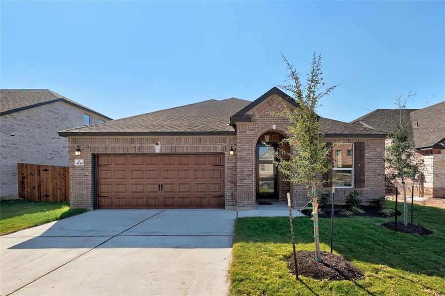 Welcome to your dream home in Round Rock! Beautifully manicured lawn and lush landscaping enhance the curb appeal.