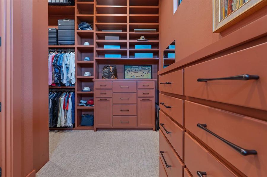 Of of two custom curated dream walk-in closets with high-end organizational systems.