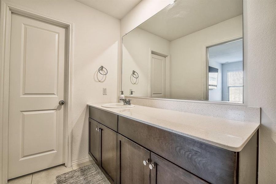 Bathroom with tile patterned flooring and vanity