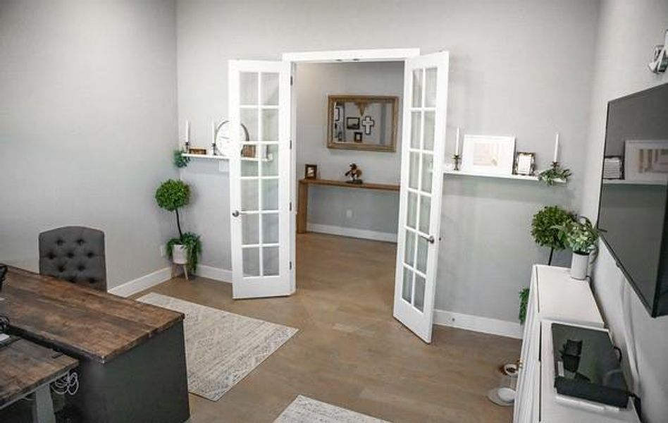 Office featuring wood-type flooring and french doors