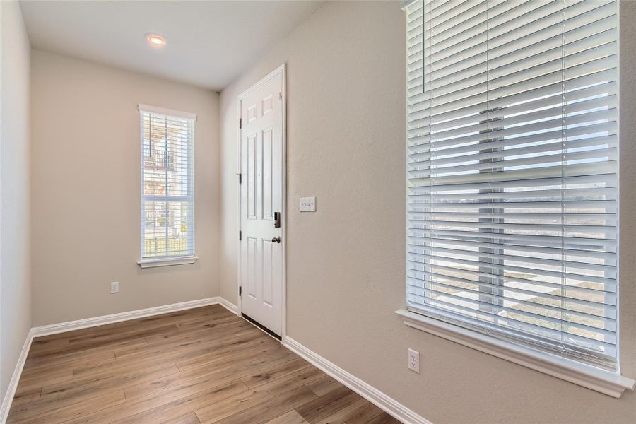 Inside the entry foyer welcomes you home with space for your credenza and bench seating.