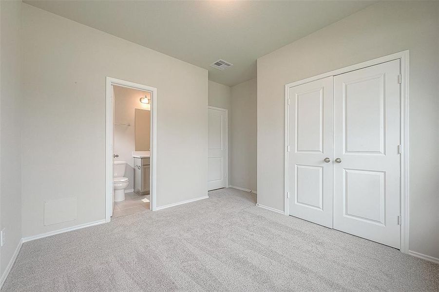 A convenient downstairs guest bedroom with a private bath.