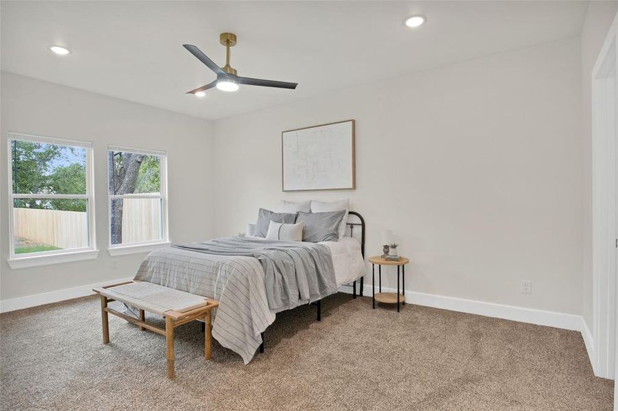 Carpeted bedroom with ceiling fan