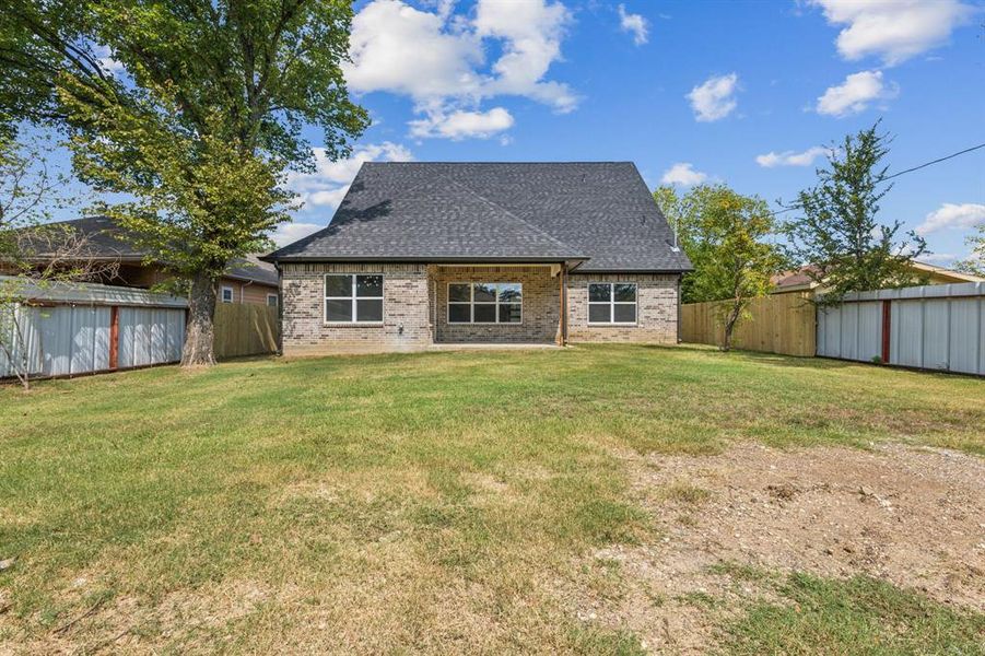 Rear view of property featuring a lawn