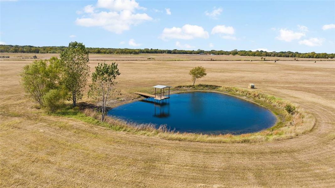 Birds eye view of property featuring a water view and a rural view