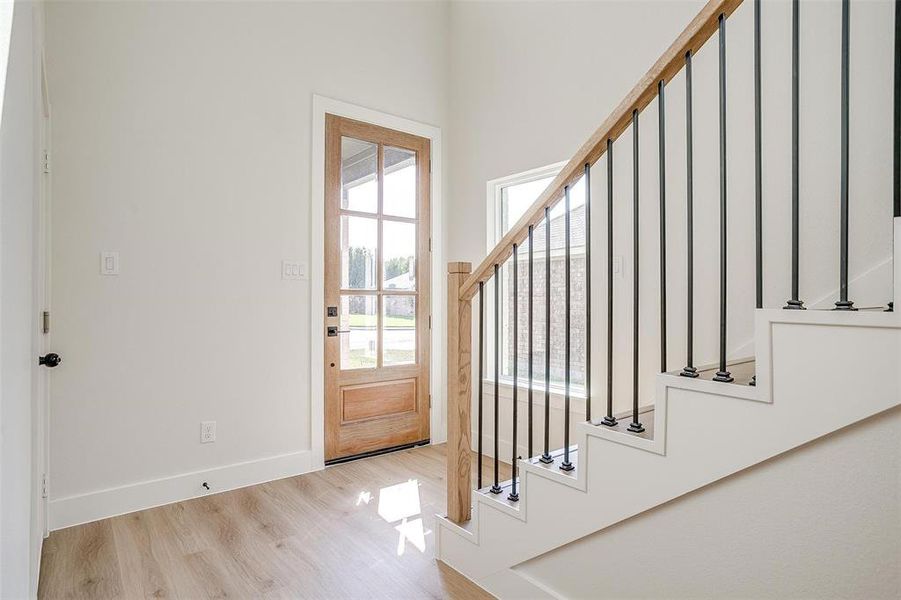 The foyer is filled with natural light and has soaring 19 foot ceilings