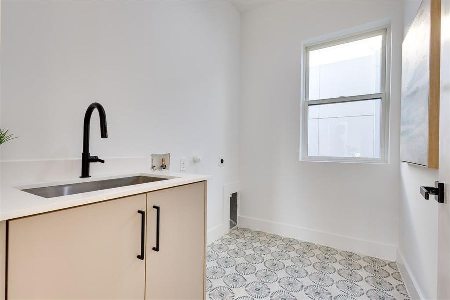 Washroom featuring washer hookup, hookup for an electric dryer, cabinets, and sink