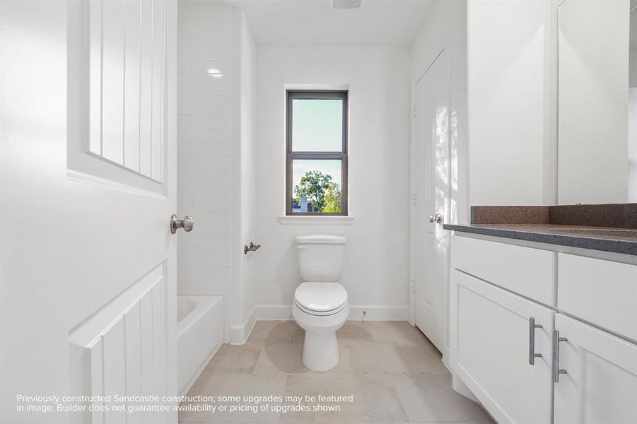 Graceful Convenience: The hall bathroom serves as an oasis of elegance and practicality, thoughtfully equipped to cater to both guests and family with stylish fixtures and serene finishes.