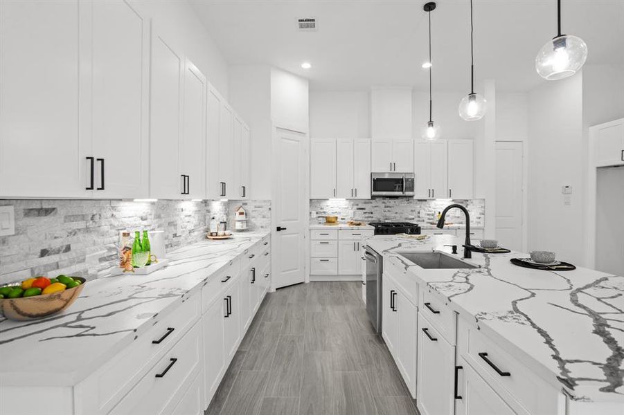 This space is accented with matte black finishes and soft closing cabinets and drawers.