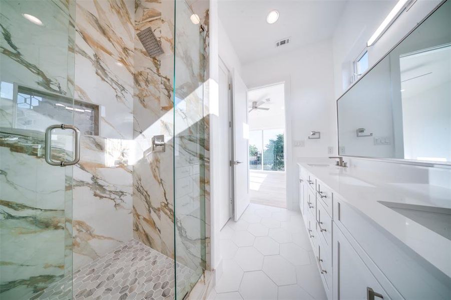 Bathroom featuring vanity, ceiling fan, tile patterned floors, and an enclosed shower