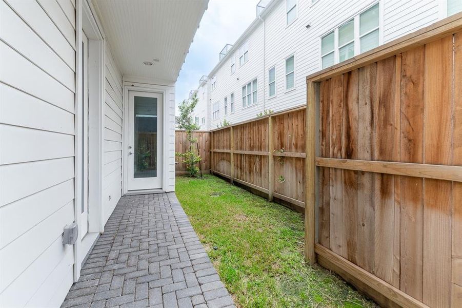 Fenced back yard with back porch.