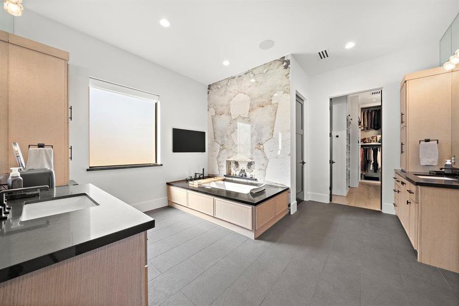 Primary bath features a jacuzzi Tub with led ambient light thereapy and heater, Desert Soul Porcelain Slabs.  Mateo Crystal Vanity Lights.  Atmos Speakers and Picture TV - Pure Luxury