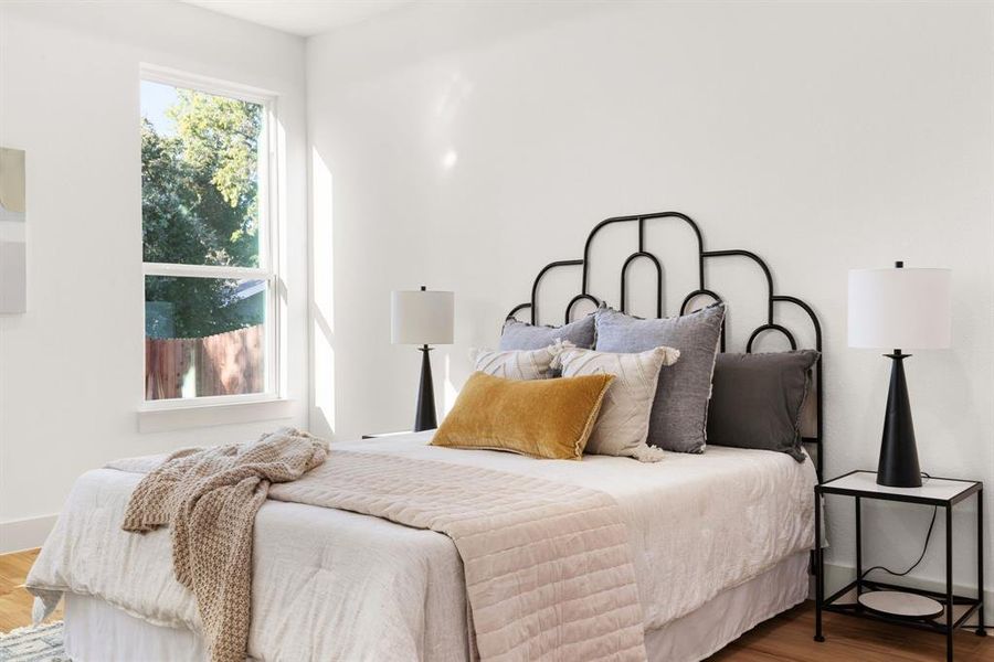 Bedroom with hardwood / wood-style flooring