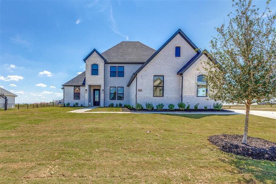 French country style house with a front yard