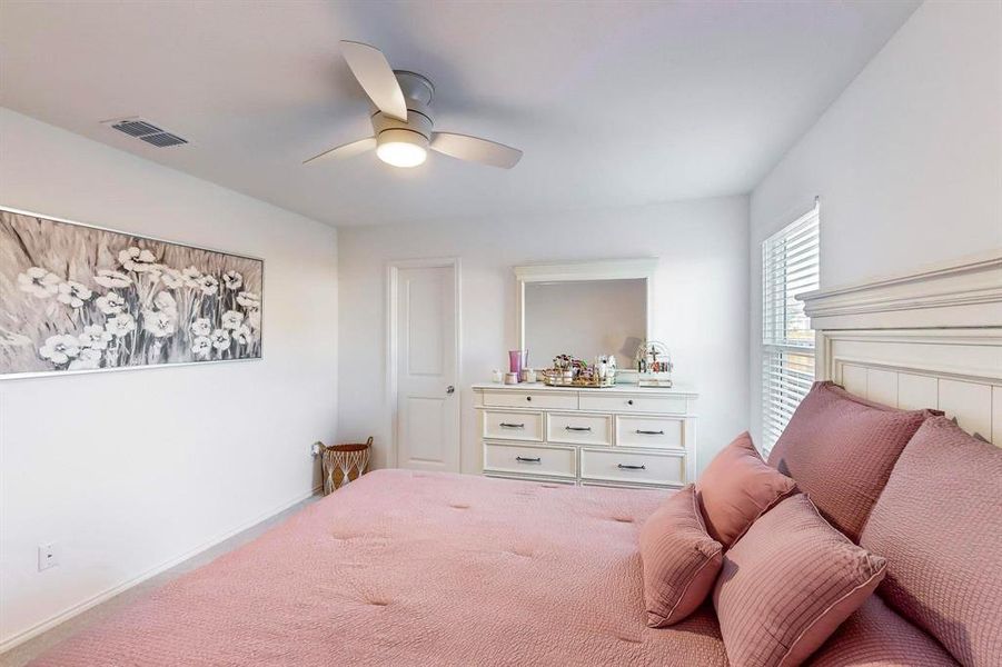 Carpeted bedroom with ceiling fan