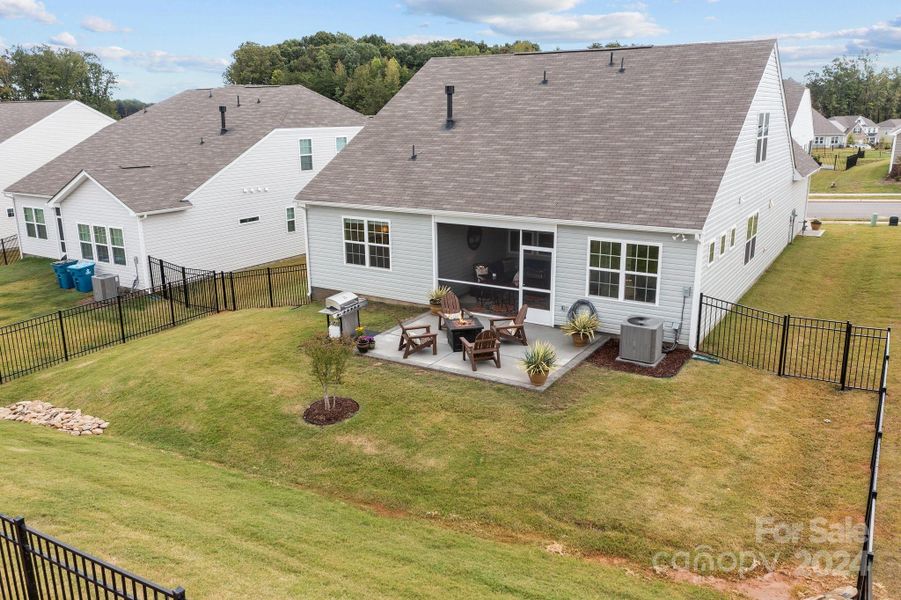 Backyard is fully fenced and ready for you! Details include an expanded patio with grill bump out, sodded yard and river rock in the drainage area.  Access to screen porch and entry to home through patio.