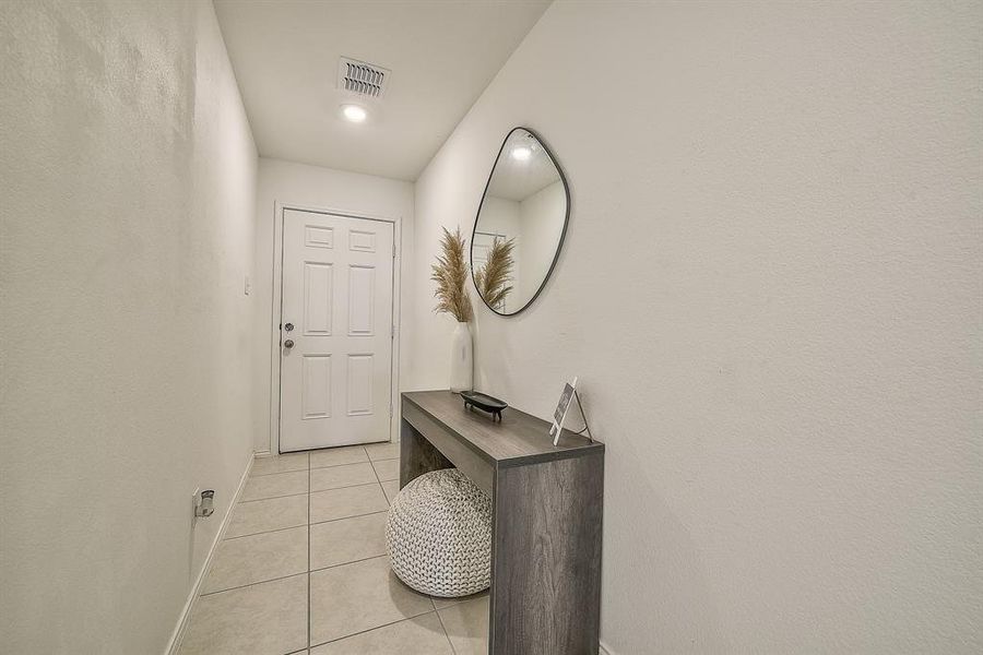 Doorway to outside featuring light tile patterned floors