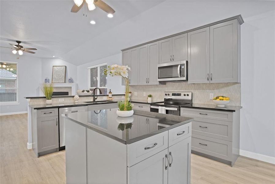 Kitchen is a chef's delight with ample counter space, large island and lofted ceiling.