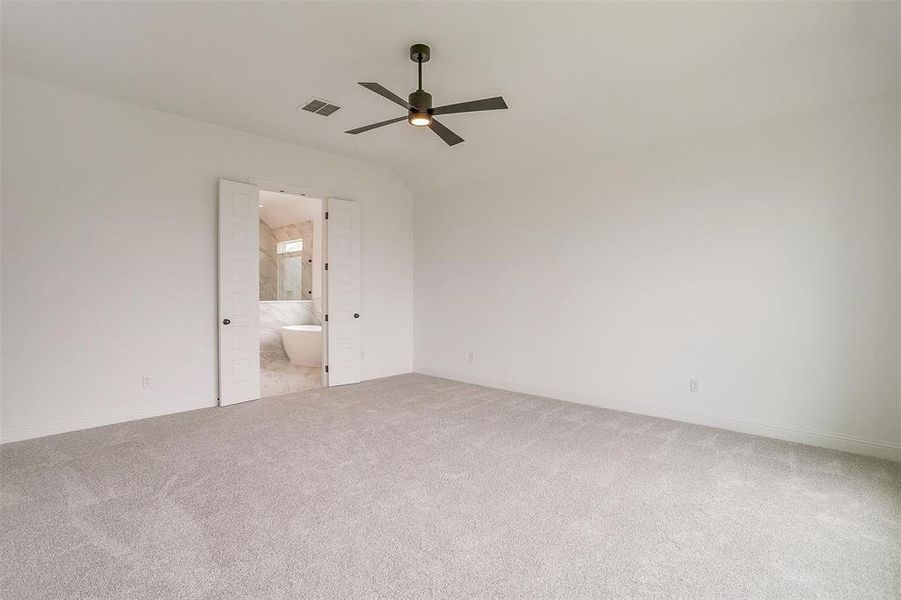 Spare room with carpet floors and ceiling fan