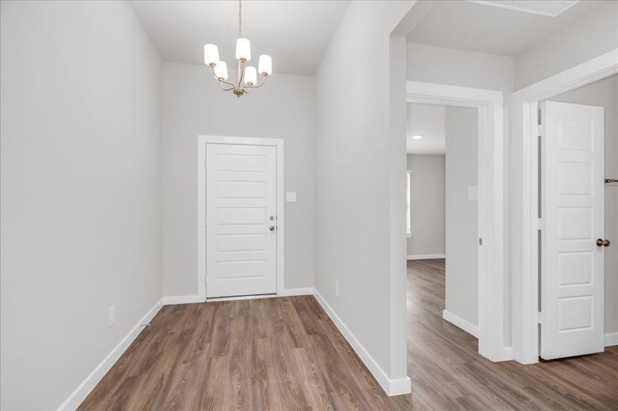 Crisp white and light gray walls in foyer are a great backdrop for furnishings.