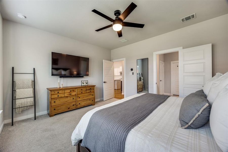 Primary Bedroom featuring carpet and ceiling fan