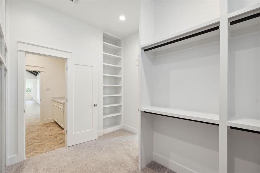 Spacious closet with light parquet flooring