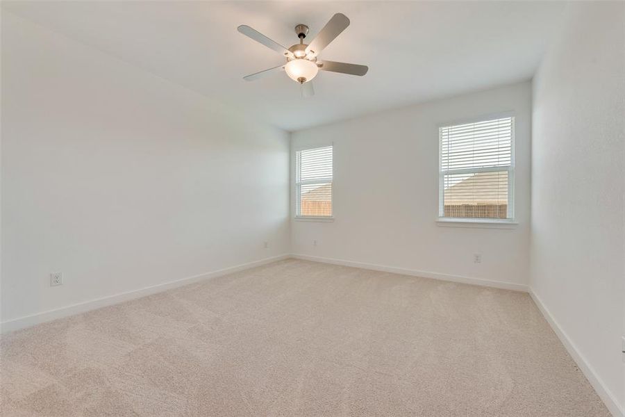 Unfurnished room with light carpet and ceiling fan