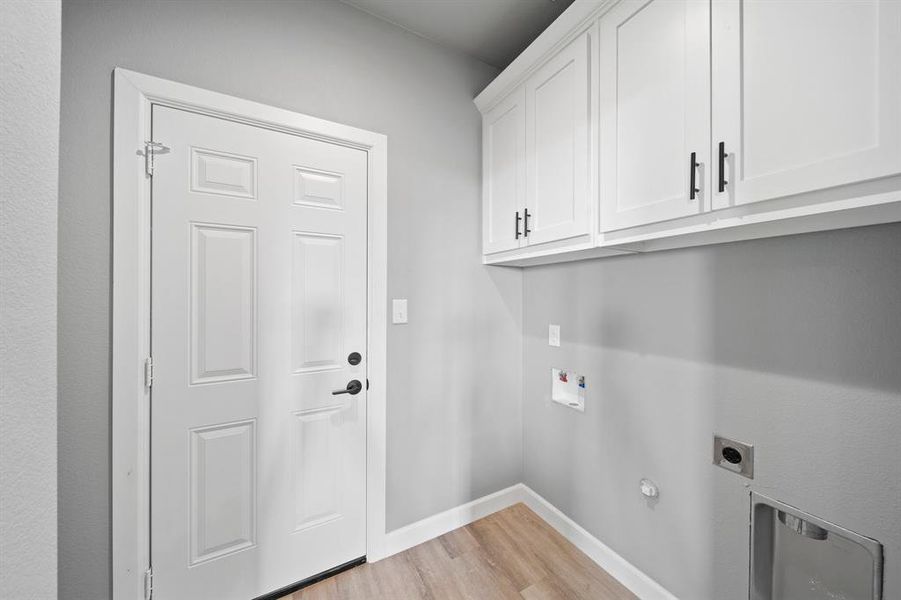 Washroom featuring hookup for a washing machine, hookup for a gas dryer, cabinets, hookup for an electric dryer, and light wood-type flooring