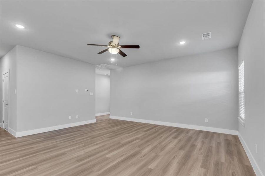 Spare room featuring ceiling fan and light hardwood / wood-style flooring