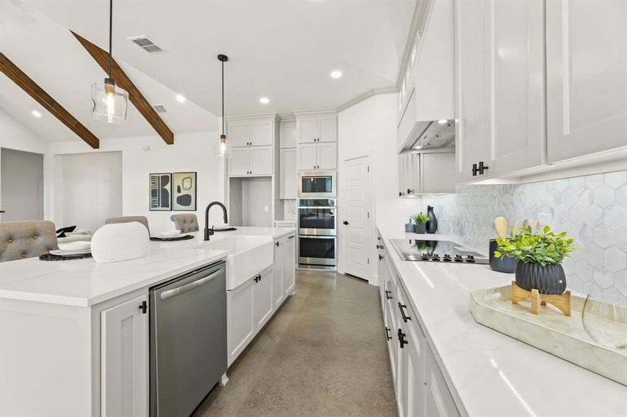 Kitchen featuring stainless steel appliances, hanging light fixtures, tasteful backsplash, a kitchen island with sink, and vaulted ceiling with beams