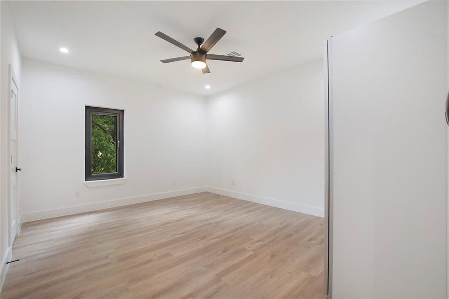 Spare room with ceiling fan and light wood-type flooring