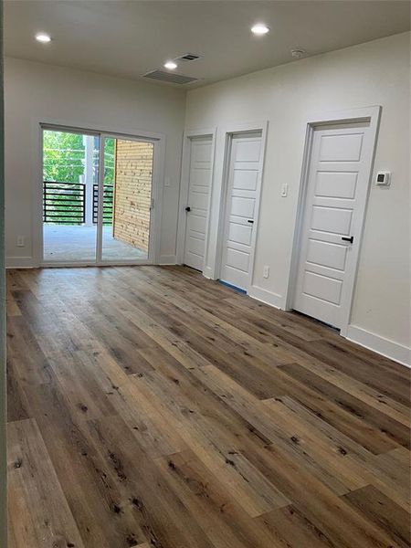 Loft featuring access to balcony and dark hardwood / wood-style flooring