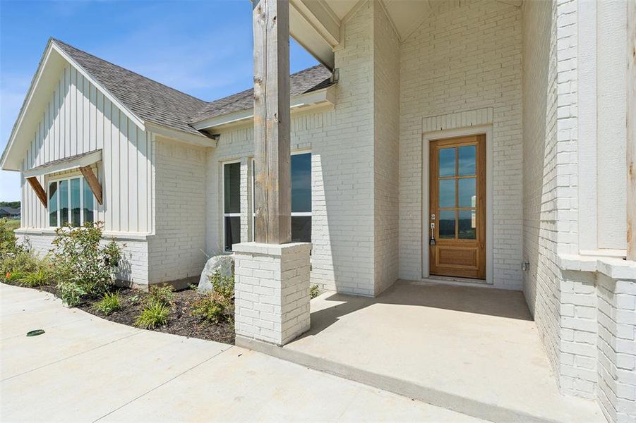 View of exterior entry with a patio