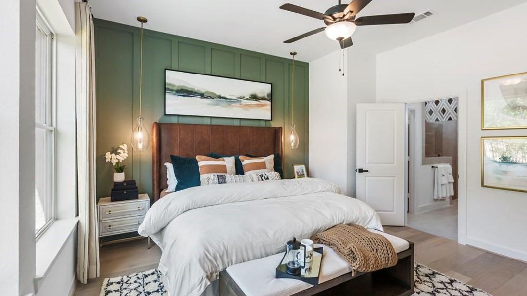 The Owner's Retreat features a stunning accent wall that adds elegance and style, complemented by strategically placed hanging bedside lights for functional lighting and ambiance.