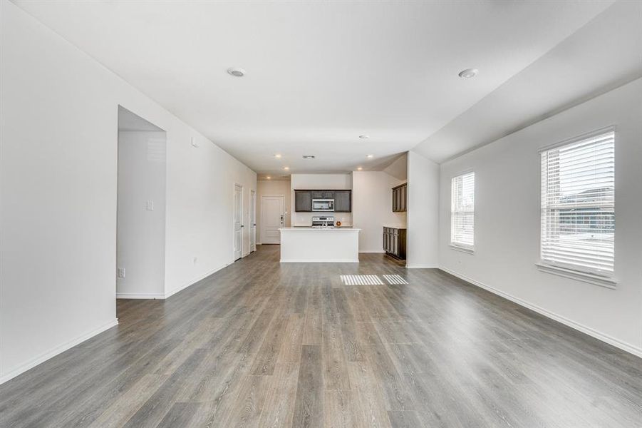 Unfurnished living room featuring dark hardwood / wood-style floors