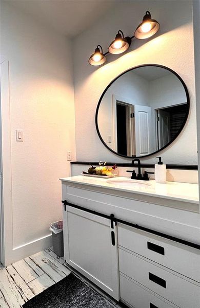 Second Bathroom with wood-type flooring and vanity