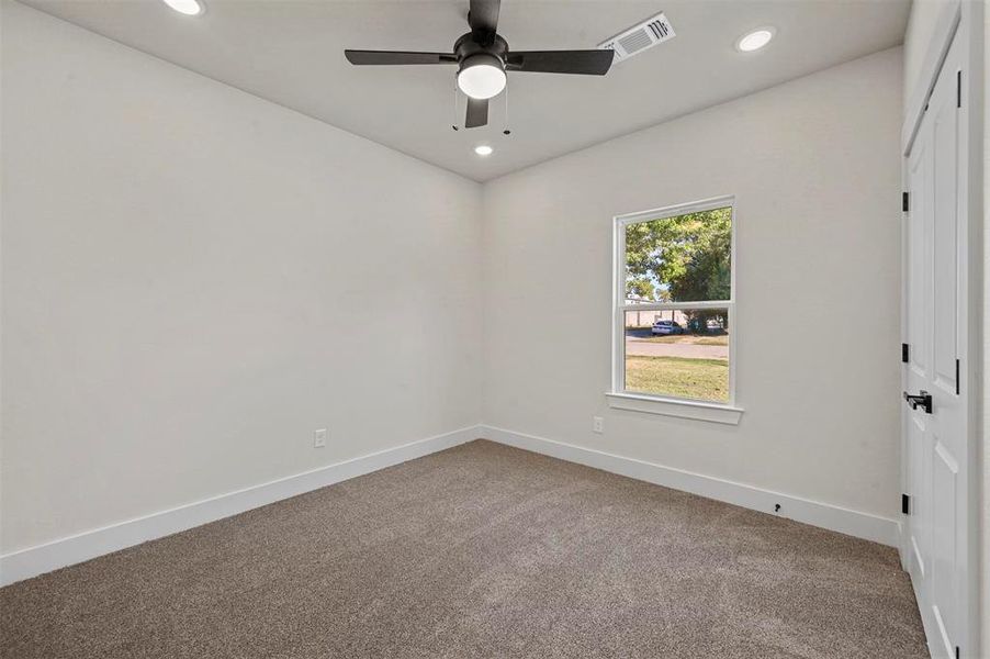 Unfurnished room featuring carpet floors and ceiling fan