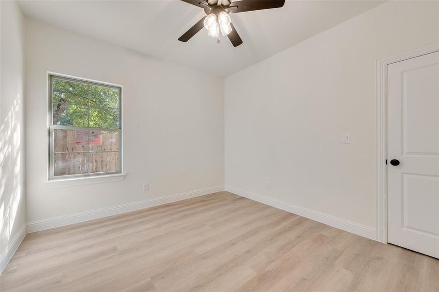 Spare room with light hardwood / wood-style floors and ceiling fan