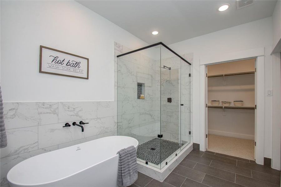 Primary Bathroom features a gorgeous freestanding tub and a separate shower with semi-frameless glass shower door. Model home photos - FINISHES AND LAYOUT MAY VARY!Ceiling fans are NOT INCLUDED!