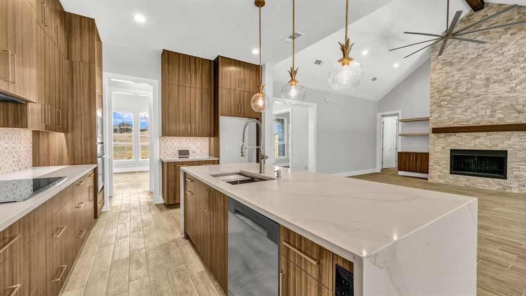 Kitchen with appliances with stainless steel finishes, wine cooler, decorative backsplash, and light hardwood / wood-style floors