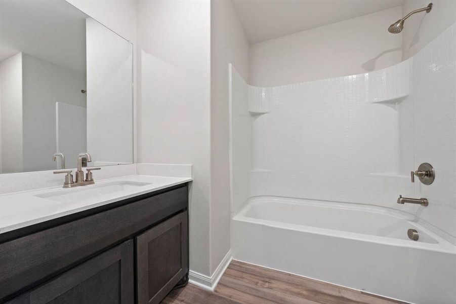 Bathroom with vanity, wood-type flooring, and  shower combination