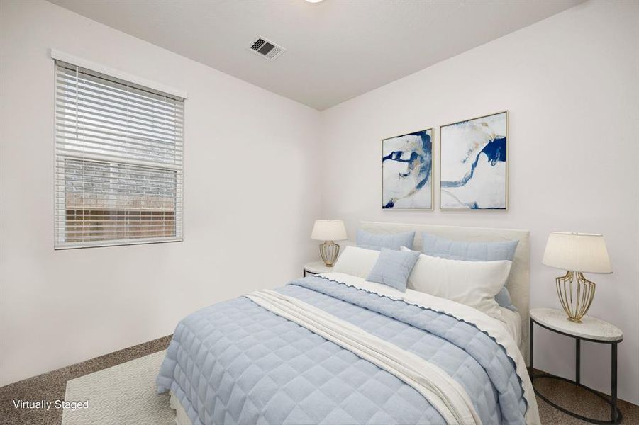 Secondary bedroom features plush carpet, neutral paint, lighting and a large window with privacy blinds and aptly sized closet.