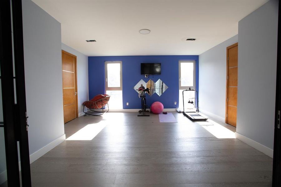 Exercise room featuring dark wood-type flooring
