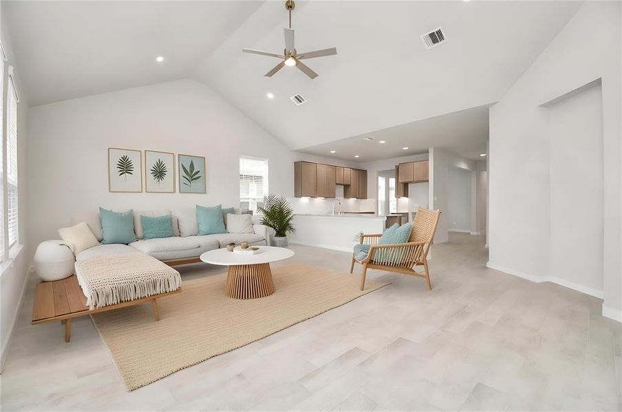 *Virtually Staged* Gather the family and guests together in your lovely living room! Featuring soaring high ceilings, recessed lighting, ceiling fan, custom paint, gorgeous floors, and large windows that provide plenty of natural lighting throughout the day.