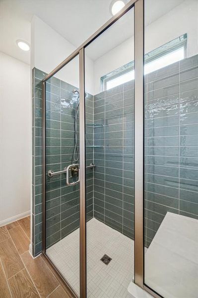 Standup shower in bath with bench for resting.