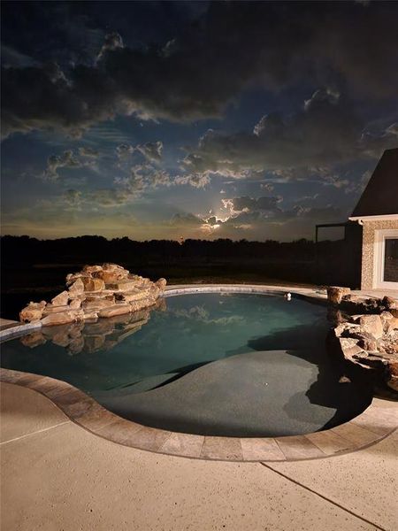 View of pool at dusk