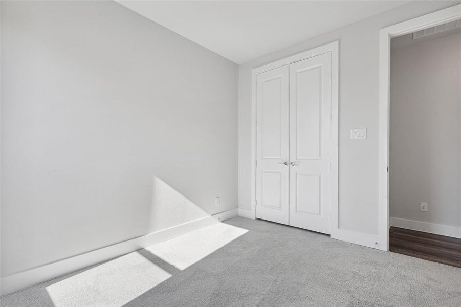 Unfurnished bedroom featuring a closet and carpet