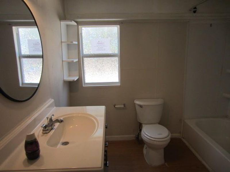 Full bathroom featuring plenty of natural light, toilet, tub / shower combination, and vanity