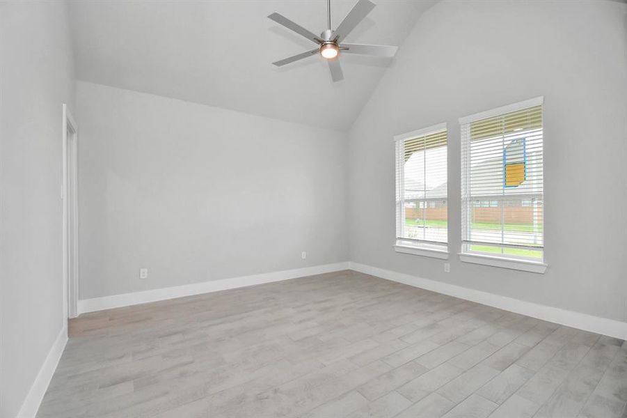 Another view of the spacious office adorned with large windows for natural light.