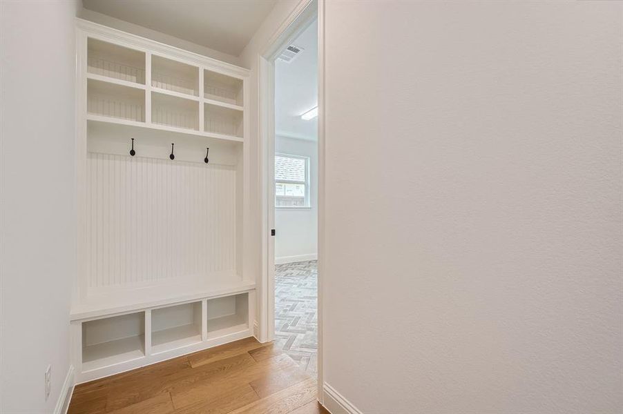 Mudroom with light hardwood / wood-style flooring